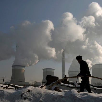 A villager walks past a coal-fired power plant in Shanxi province, one of the more developed fossil fuel regions. Photo: Reuters