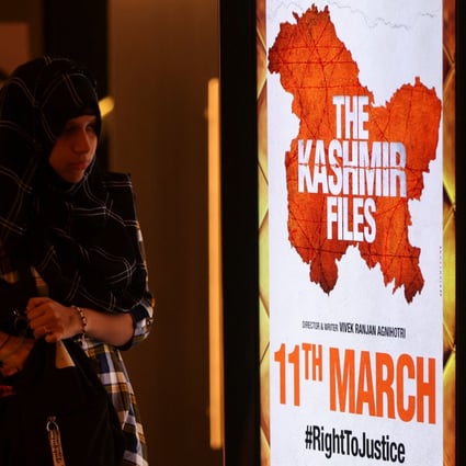 A woman walks past a poster for “The Kashmir Files” inside a cinema in Mumbai last week. Photo: Reuters