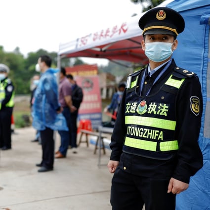 Police officers stand guard at a checkpoint at the entrance of Simen village near the site where a China Eastern Airlines Boeing 737-800 plane crashed on Monday. Photo: Reuters