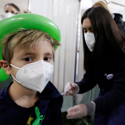 A child receives a vaccination against Covid-19 at a school in Naples, Italy, in January. Photo:  Reuters