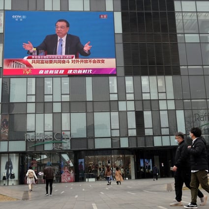 A giant screen shows a news conference by Premier Li Keqiang, following the closing session of the National People’s Congress in Beijing on March 11. Photo: Reuters