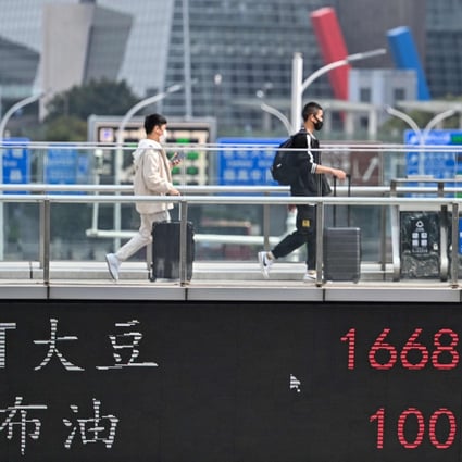 A display board showing commodity prices in Shanghai’s Lujiazui financial district on March 16, 2022. Photo: AFP