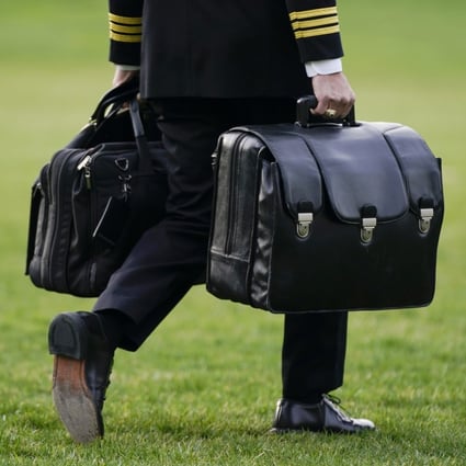 A US military aide carries the ‘President’s emergency satchel’, also known as ‘the football,’ which contains nuclear launch codes, before boarding Marine One behind President Joe Biden. Photo: AP