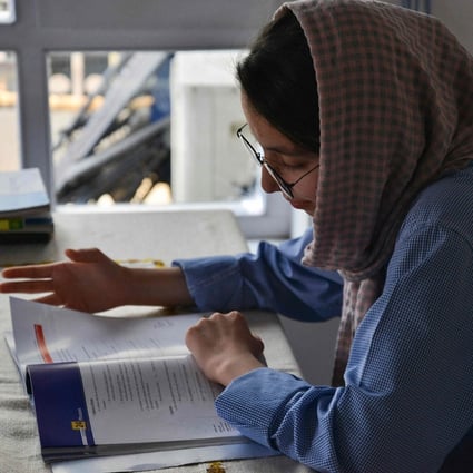 Nargis Jaffari studies at home in Kabul days after Taliban’s U-turn on allowing Afghan girls back to school. Photo: AFP