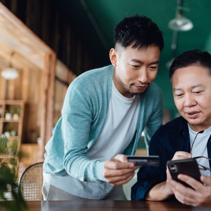 Many Hong Kong residents, including the elderly, have had to embrace digital banking practices because of restrictions on business opening hours and social distancing measures imposed during the Covid-19 pandemic. Photo: Getty Images / AsiaVision