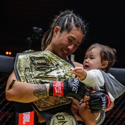 Angela Lee celebrates with her infant daughter after retaining her title at ONE X. Photos: ONE Championship