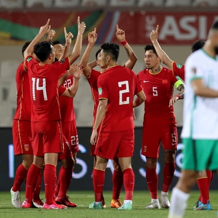 Chinese players point to the sky after scoring a penalty against Saudi Arabia as they pay tribute to the victims of the recent air crash back home in Guangxi. Photo: Xinhua