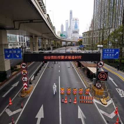 A worker in a protective suit walks along a Shanghai highway, amid Covid restrictions. Photo: Reuters