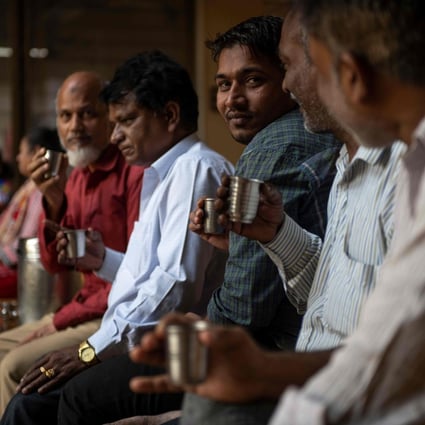 Men drink tea during a break at a factory in Mumbai. Tea is an ever-present part of Indian culture. Photo: AFP