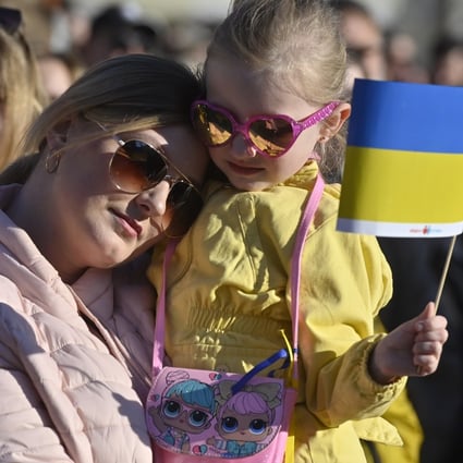 A woman and her daughter watch the streaming of benefit concert Save Ukraine – #StopWar at Prague’s Old Town Square in Czech Republic. Photo: CTK / DPA