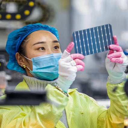 A worker checks photovoltaic modules used for small solar panels at a factory in Haian in China’s Jiangsu province in January. Photo: AFP