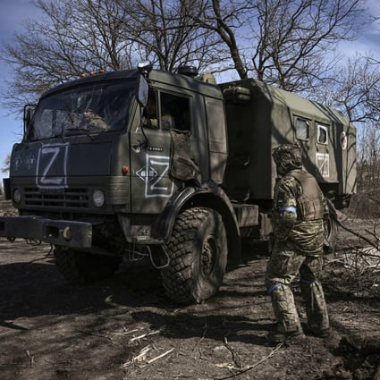 Ukranian troops drive a captured Russian military vehicle in a village east of Kharkiv on Monday. Photo: AFP