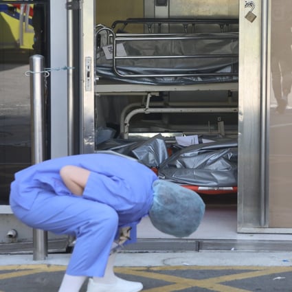 A nurse inspects bodies at Queen Elizabeth Hospital earlier this month. Photo: Jelly Tse