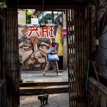 A woman walks through an alley in the Talad Noi neighbourhood, long home to the ethnic Chinese communities of Bangkok. Photo: AFP