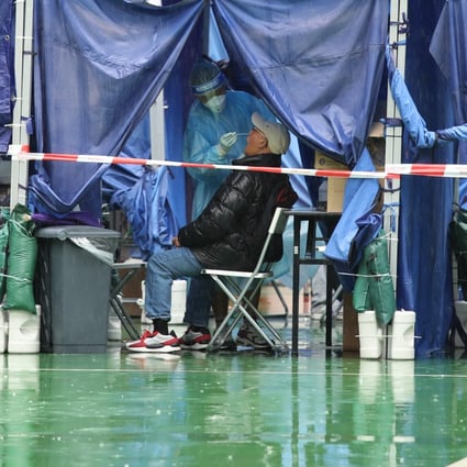 A resident gets a Covid-19 test on a rainy day at a mobile specimen collection station in the MacPherson playground in Mong Kok on March 28. Photo: Yik Yeung -man