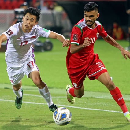 China’s Dai Wai-tsun (left) and Oman’s Salaah al-Yahyaei battle for the ball during their 2022 Qatar World Cup Asian Qualifiers match at the Sultan Qaboos Sports Complex. Photo: AFP