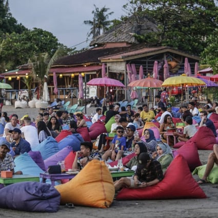 Tourists on Canggu Beach in Bali, Indonesia, on March 12, 2022. Photo: Anadolu Agency via Getty Images