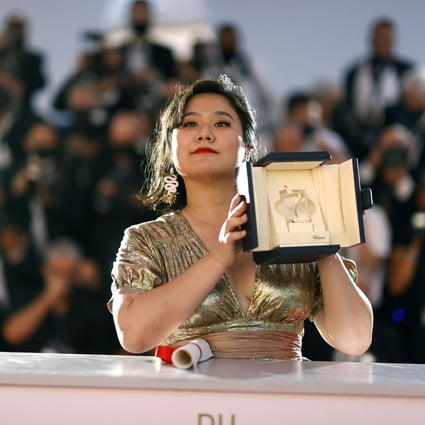Hong Kong director Tang Yi poses with the Short Film Palme d’Or for her film “All the Crows in the World” at the Cannes Film Festival on July 17, 2021. The cultural and creative industries have become a focus of development in Hong Kong. Photo: EPA-EFE 