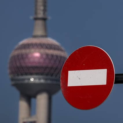 A ‘no entry’ sign stands on the street while the Pearl of the Orient Tower, one of Shanghai’s most famous landmarks, stands in the background in Pudong, which is under lockdown, is seen in the background on 29 March 2022. Photo: EPA-EFE