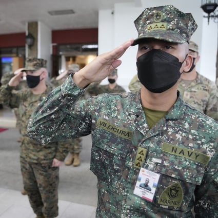 Philippine and US soldiers salute during the opening ceremony of the Balikatan drills on March 28, 2022. Photo: AP