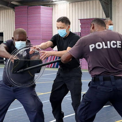 A police officer from China trains Solomon Islands officers. The two nations have agreed to a wide-ranging security pact. Photo: AFP
