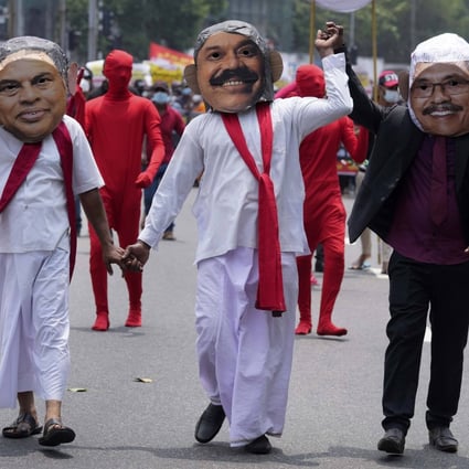Members of the Socialist Youth Union, dressed as Sri Lankan president Gotabaya Rajapaksa and his brothers Basil and Mahinda, protest against the country’s worst economic crisis. Photo: AP