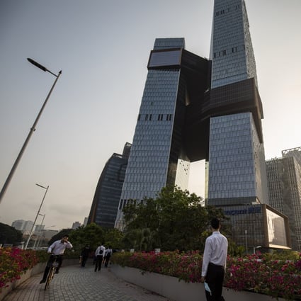 People walk past Tencent Holdings headquarters in Shenzhen on March 20, 2021. Tech giants in China have been subject to stricter regulations. Photo: Bloomberg