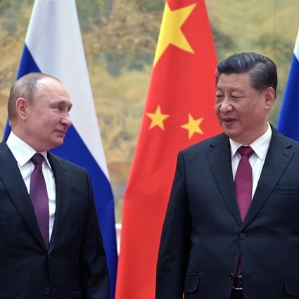Russian President Vladimir Putin, left. and Chinese President Xi Jinping pose for a photograph during their meeting in Beijing on February 4, 2022. After years of closer ties between Beijing and Moscow, Chinese firms are now gauging the risks in their exposure to Russia following its invasion of Ukraine. Photo: Sputnik/AFP