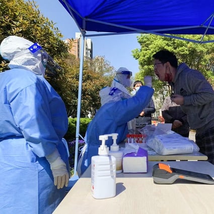 Nurses collect throat swab samples from residents of Tangqiao street in Pudong on Monday morning as part of Shanghai’s massive three-day exercise to test its 25 million people for Covid-19. Photo: Daniel Ren