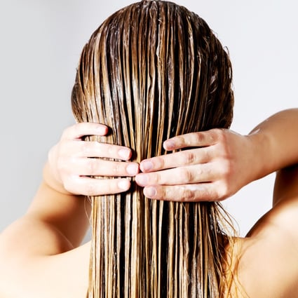 A woman applies a hair mask. Used after shampooing, they should be kept on your hair for a few minutes. They offer people with dry or damaged hair a temporary fix but are not for daily use, experts say. Photo: Shutterstock 