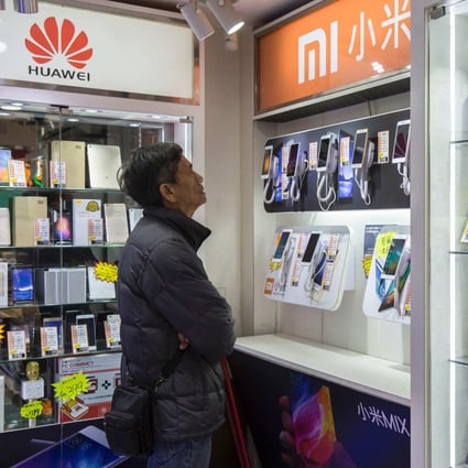 A customer browses mobile phones in a retail store in the Sham Shui Po district of Hong Kong. Electronic waste has become an increasing problem in China, which is expected to have 6 billion discarded mobile phones by 2025. Photo: AFP