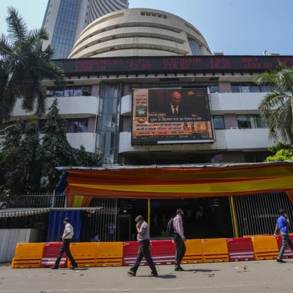 A screen showing the news featuring Russian President Vladimir Putin on the facade of the Bombay Stock Exchange building in Mumbai, India. Photo: AP