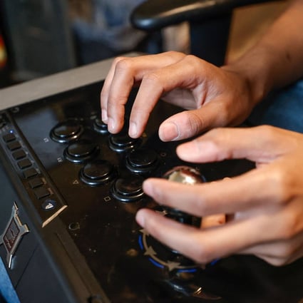 Deaf gamer Chris Robinson plays a video game in his apartment on March 26, 2022. More game makers are keeping accessibility in mind when designing software, adding settings intended to level the field for players with disabilities. Photo: AFP