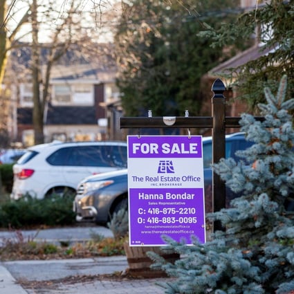 A for-sale sign is displayed outside a home in Toronto, Ontario in December 2021. Photo Reuters