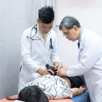 Dr Wong Lin Ho (L) and Professor Wong Pang Ong treat a patient with traditional Chinese medicine in Singapore clinic Ong Fujian Chinese Physician Hall. Photo: Facebook