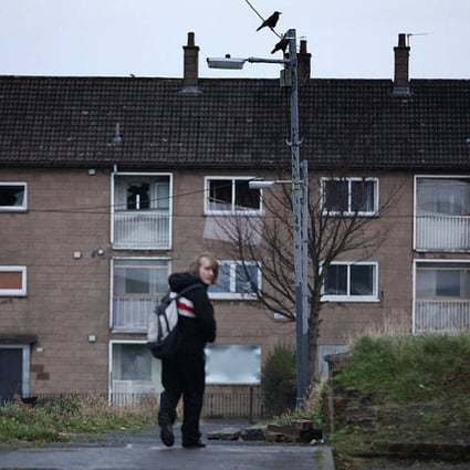 A young boy makes his way home from school on a public housing estate in Glasgow, Scotland, the setting for Douglas Stuart’s new novel, Young Mungo. Photo: Getty Images