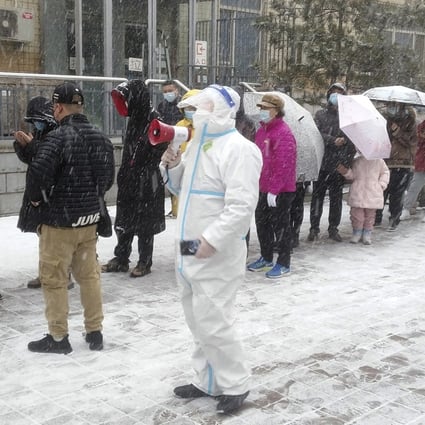 Residents of Changchun, Jilin province, line up for coronavirus testing. Authorities in the provincial capital will distribute cash and medical supplies to more than 50,000 people. Photo: AP