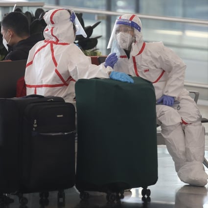 PPE-clad travellers wait to check in at Hong Kong International Airport on April 3. Photo: Xiaomei Chen