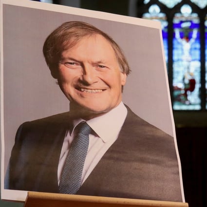 A candle and a portrait of British MP David Amess, who was stabbed to death during a meeting with constituents, are seen at a church in Leigh-on-Sea in October. Photo: Reuters