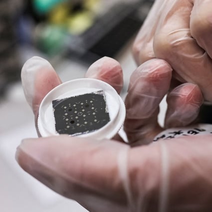An engineer holds a chip at the Taiwan Semiconductor Research Institute. China’s imports of integrated circuits decreased on year in the first quarter, according to customs data. Photo: Reuters