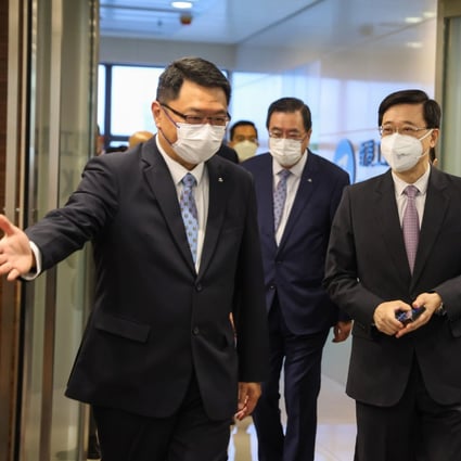 John Lee (right) visits the Federation of Hong Kong Industries on Monday. Photo: Nora Tam