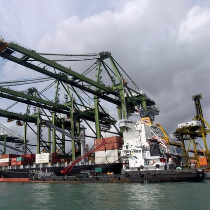 A container ship is refuelled at the dockside in Singapore in 2012. Photo: EPA