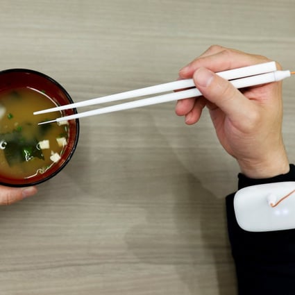 Chopsticks that can enhance food taste using an electrical stimulation waveform invented in Tokyo. Photo: Reuters