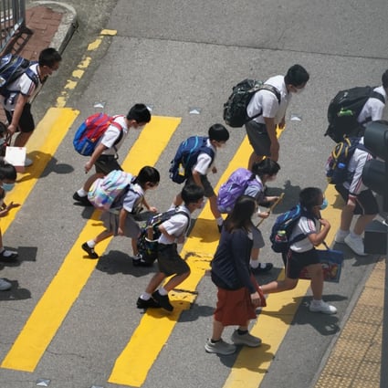 Primary school pupils in Tseun Wan cross the road, led by their teacher, in 2021. Photo: Felix Wong