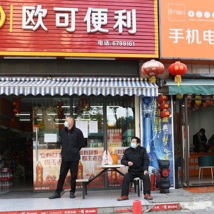 Residents rest in front of a grocery store in Yichang,  Hubei province, in March 2020. Photo: Xinhua