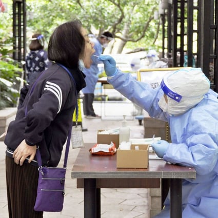 A resident of a condominium takes a PCR test in Shanghai on April 18, 2022, as a Covid-19 lockdown continues in the Chinese city. Photo: Kyodo