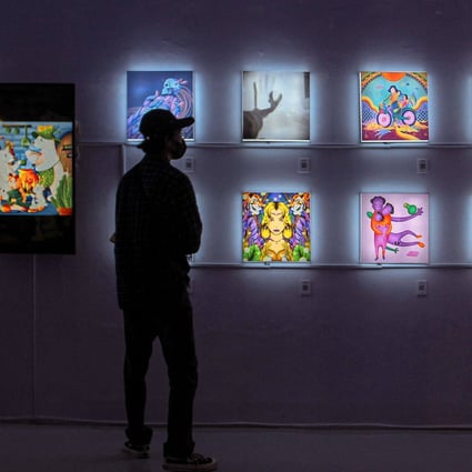 A visitor observes NFT works at an exhibition in Yogyakarta, Indonesia. A Chinese court recently ruled on a case regarding NFT art theft. Photo: AFP