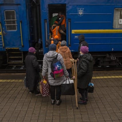Railway staff in Ukraine help elderly people board a train earlier this month. Several railway stations were attacked by Russia on Monday, with casualties reported. File photo: dpa