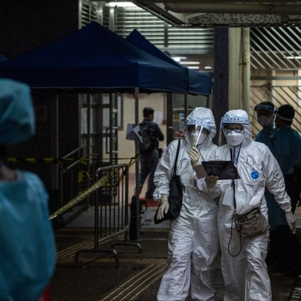 Health workers at a building lockdown in Hong Kong. Photo: EPA-EFE