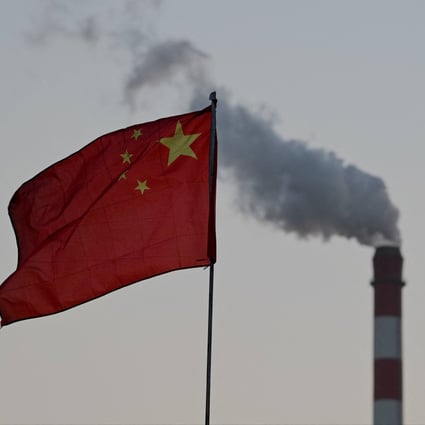 China’s national flag flutters in front of a coal-powered power station in Datong, northern Shanxi province. Photo: AFP